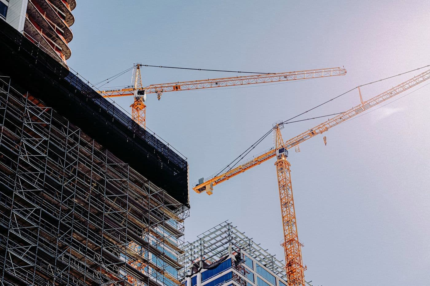 A tower crane against a blue sky