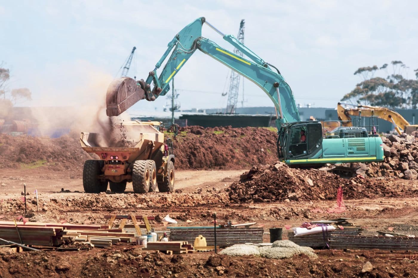 An excavator moving earth on a civil works site