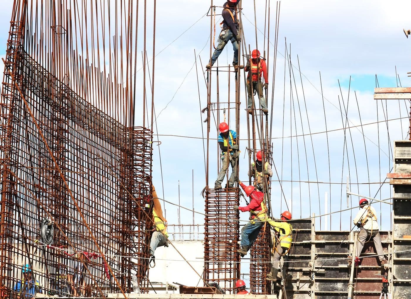 Workers fixing steel reinforcement on site