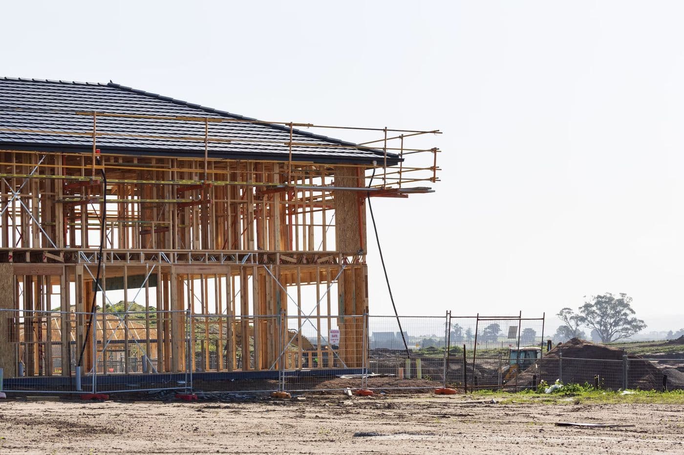 A timber-framed house with its roof structure in place